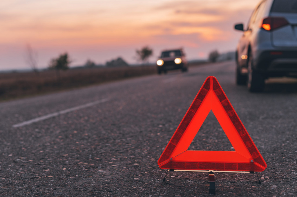 warning-triangle-sign-on-the-road-in-sunset-VAJSG7J-scaled.jpg